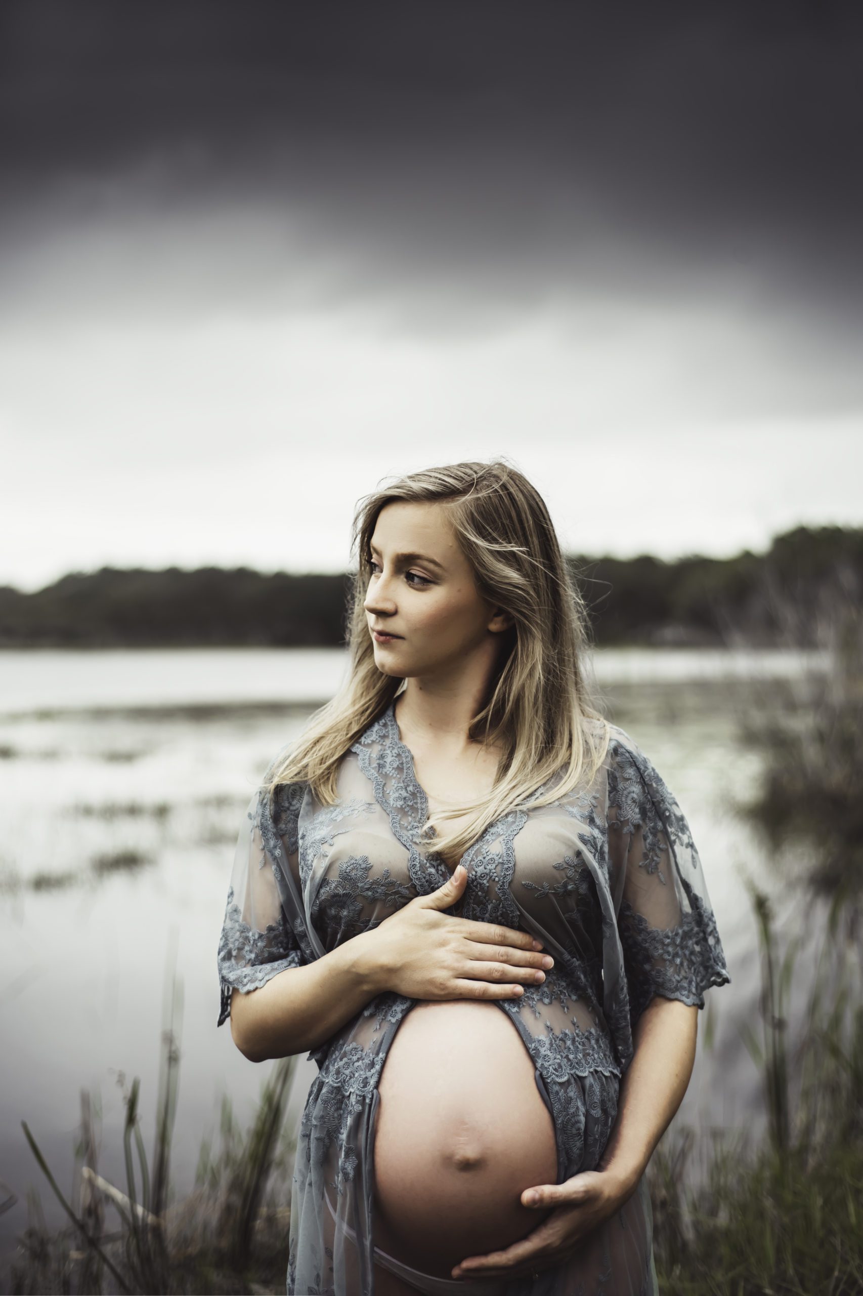 dark and moody maternity photo by lake