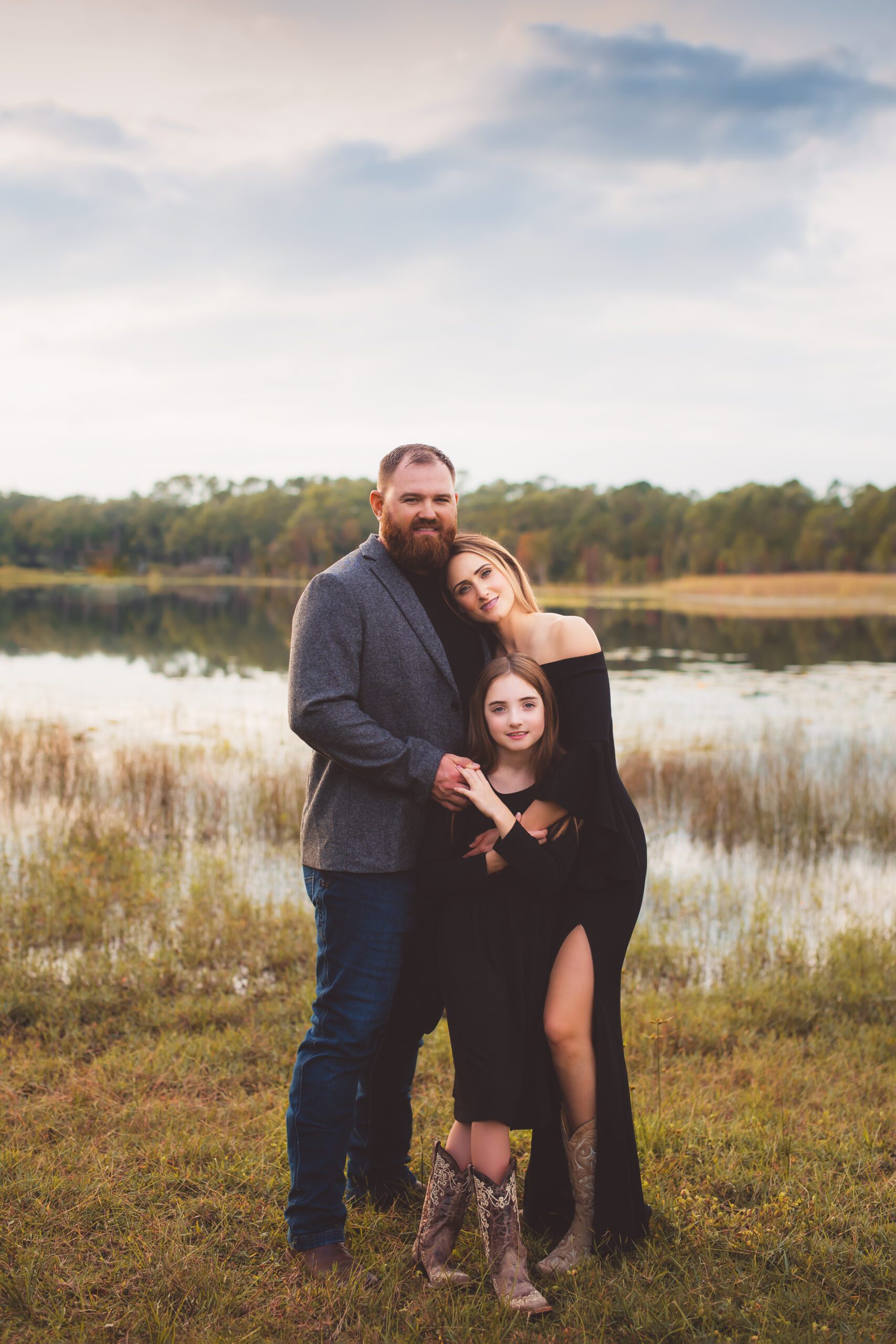 family of three by a lake